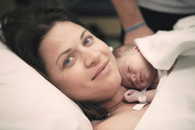 color birth photo of a new first time mom and her son