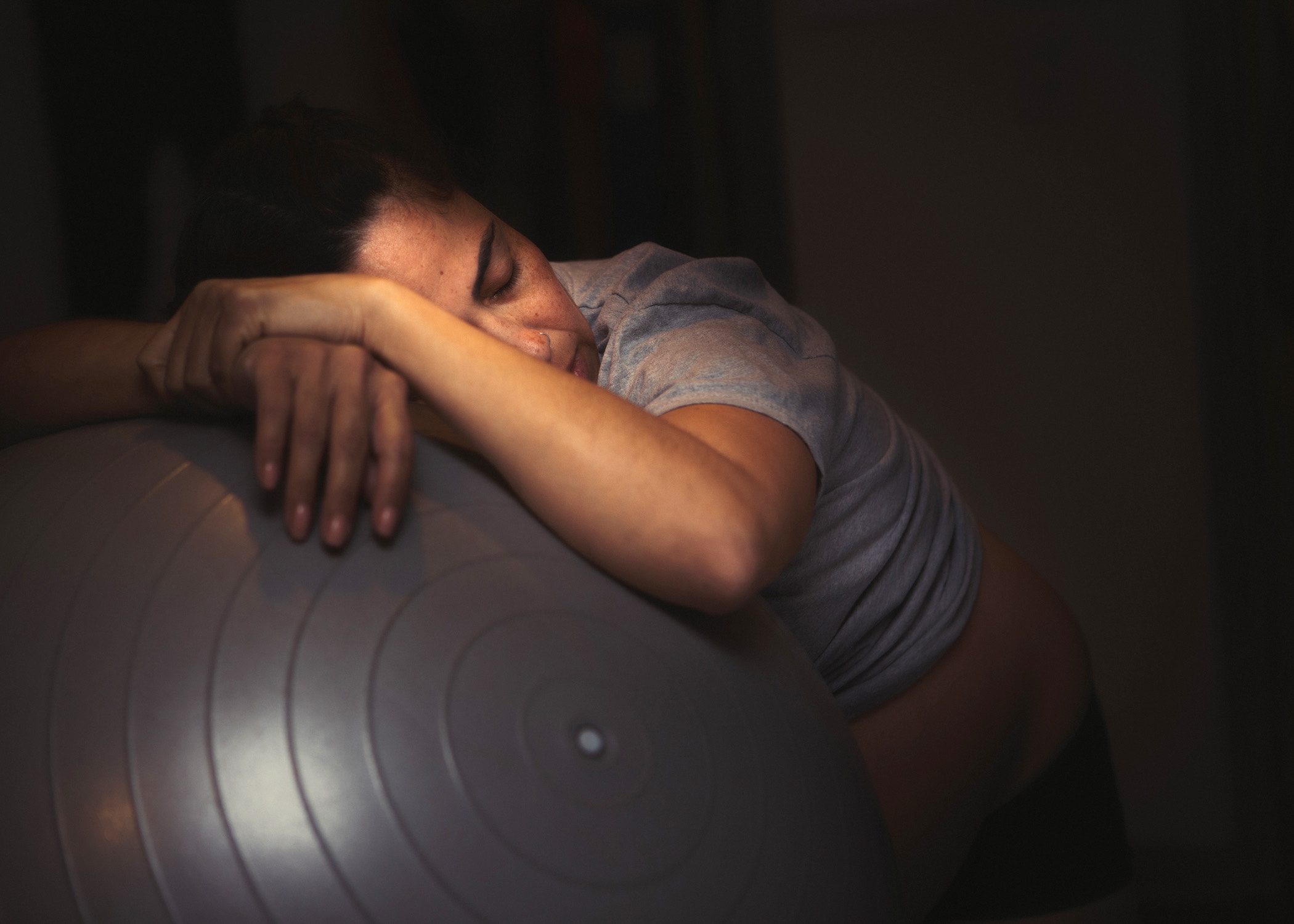 color birth photo of a mother laboring on her birth ball during her homebirth in North Hollywood.