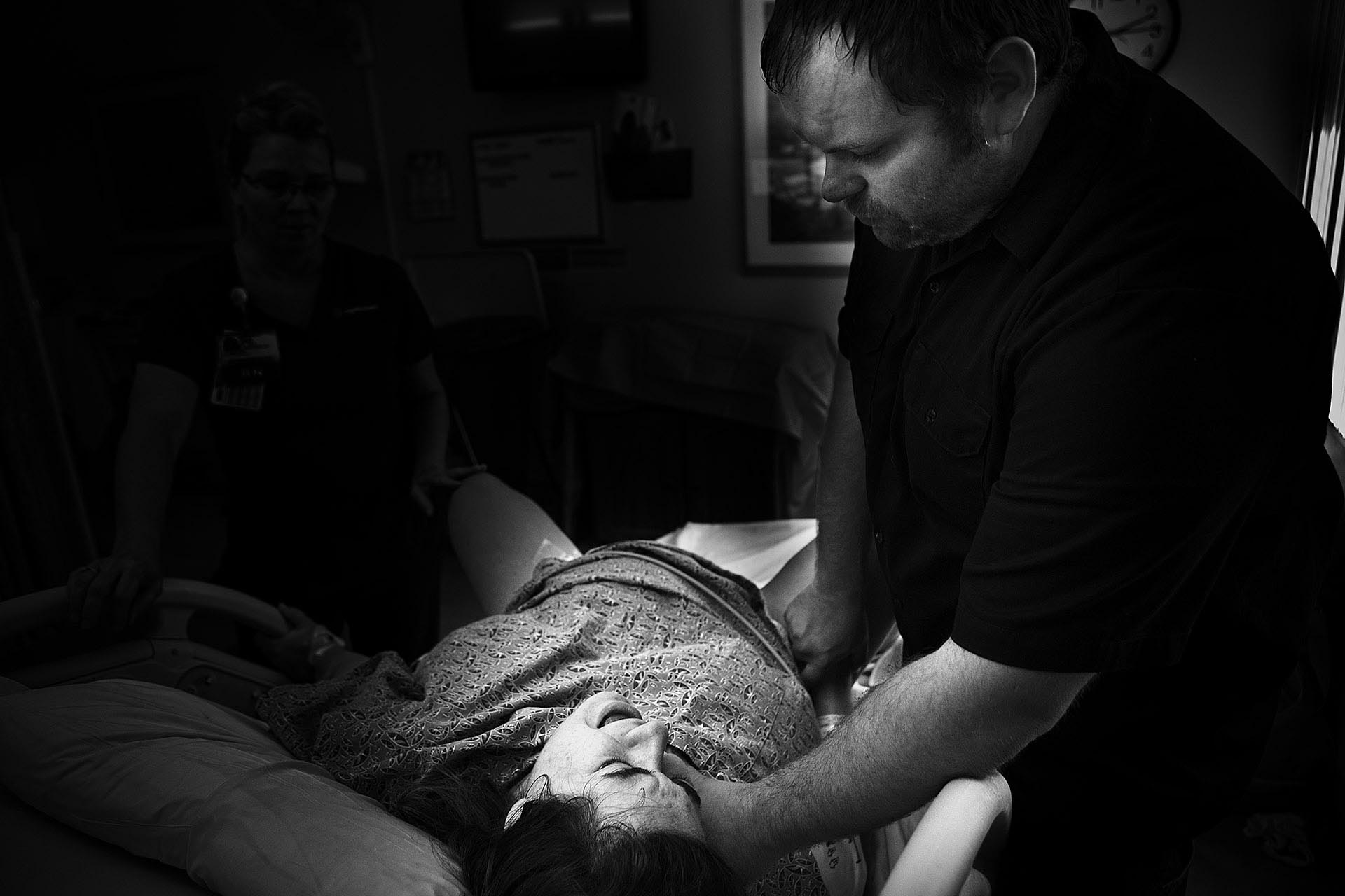 Los Angeles birth photography black and white birth photography image by Leona Darnell showing a woman screaming during delivery in Glendale California