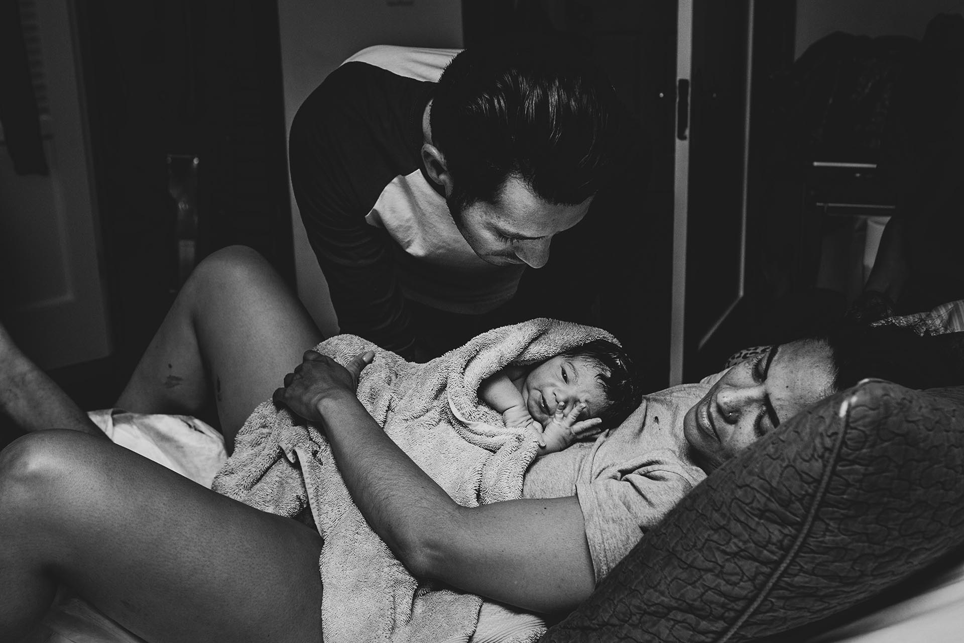 Los Angeles birth photography black and white birth photography photo by Birth and Beauty showing mom and dad and their new son in Los Angeles California