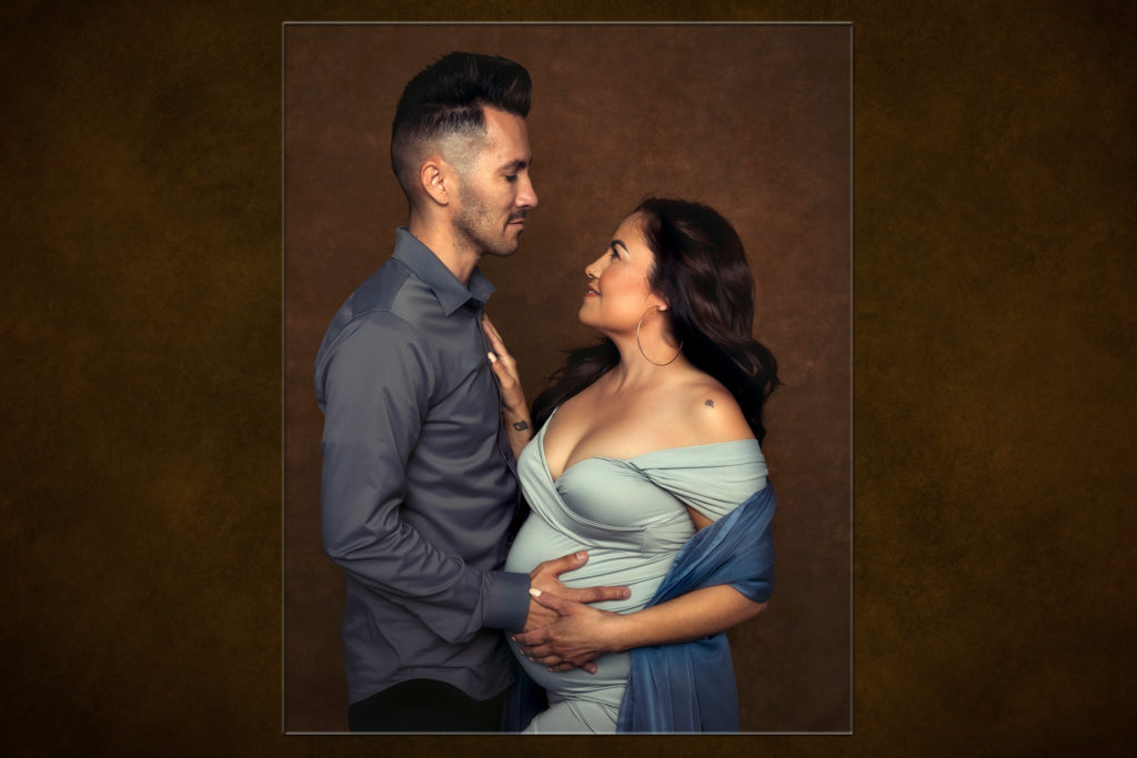Color Maternity images of a woman and her partner embracing