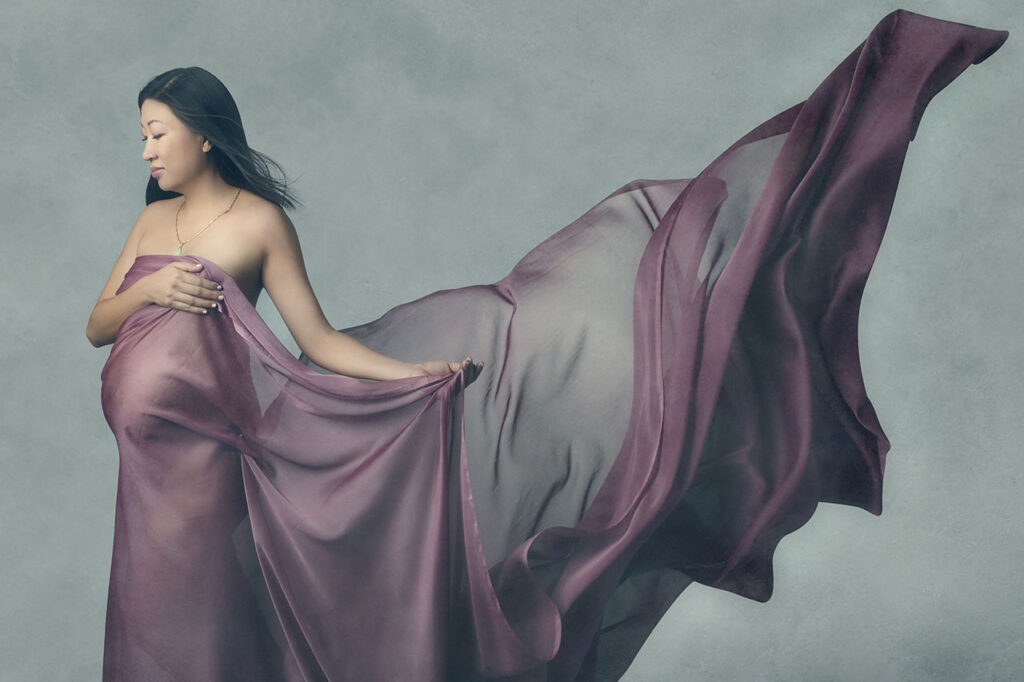 Maternity Sessions During COVID: Los Angeles maternity photographer, Leona Darnell, shows an Asian woman with chiffon draped around her.