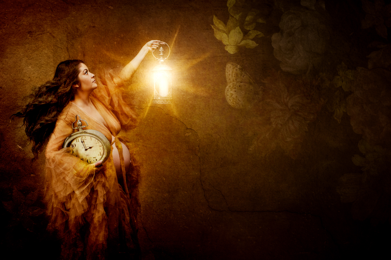 fine art maternity portrait of a woman holding a clock and lantern