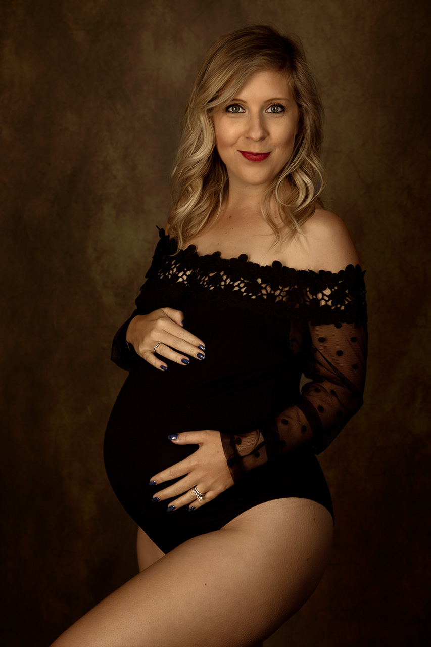 Birth and Beauty shows a pregnant woman in a black bodysuit with this maternity photography portrait.