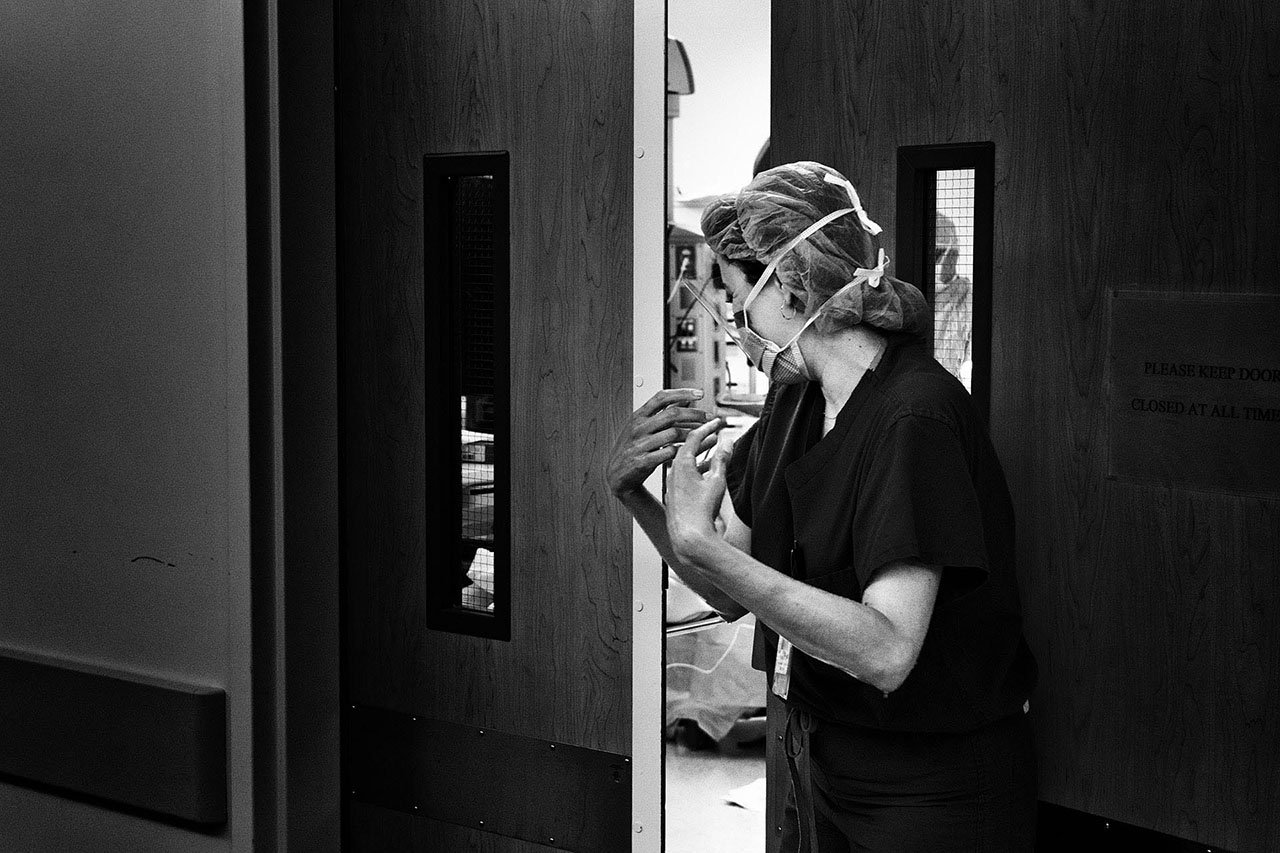 black and white image of a doctor going into the OR for a cesarean birth by Santa Monica birth photographer, Leona Darnell