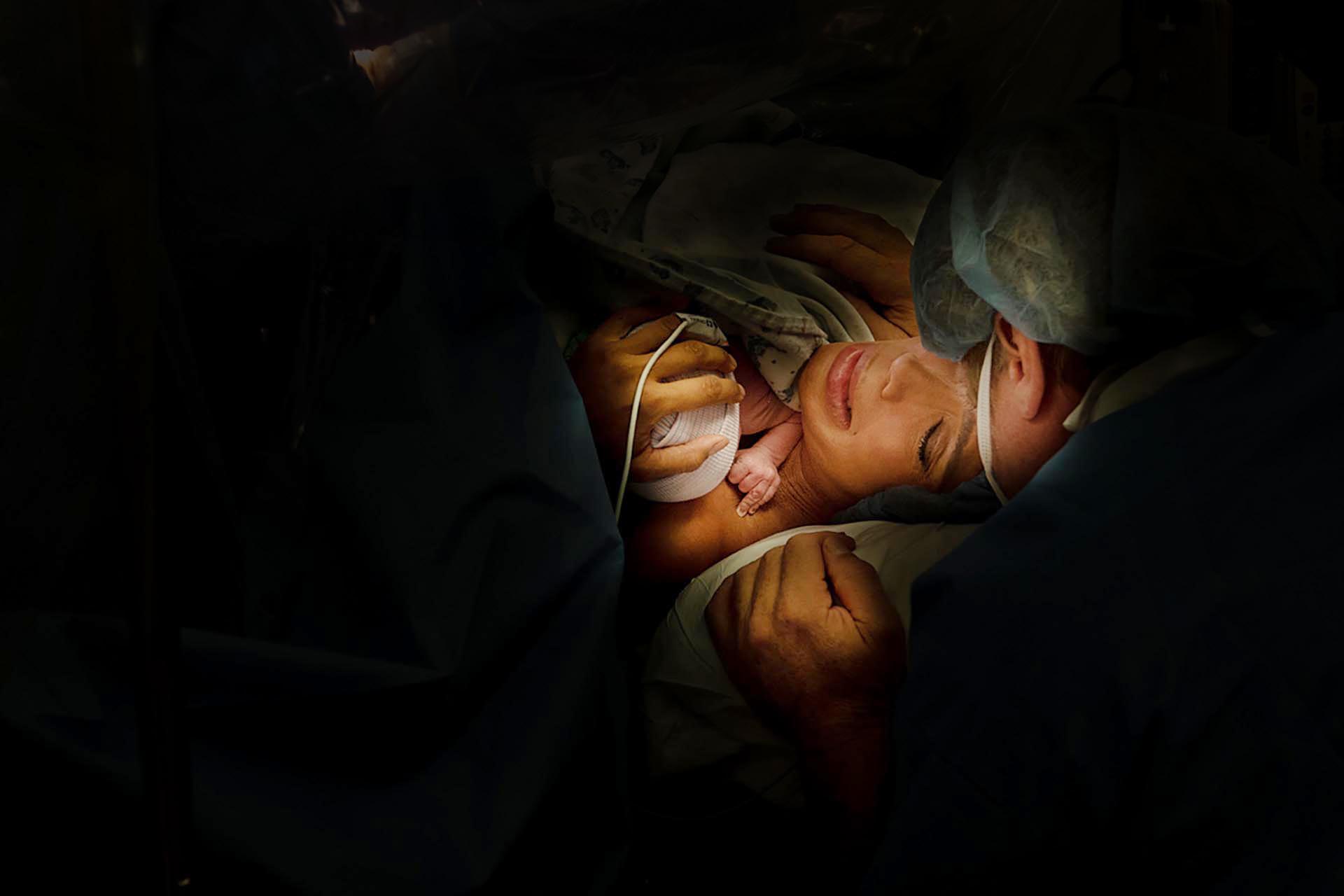 santa monica birth photography image of a mother holding her daughter after a cesarean birth.