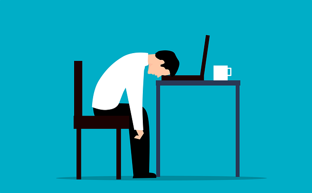 cartoon picture of a tired person sitting at a desk