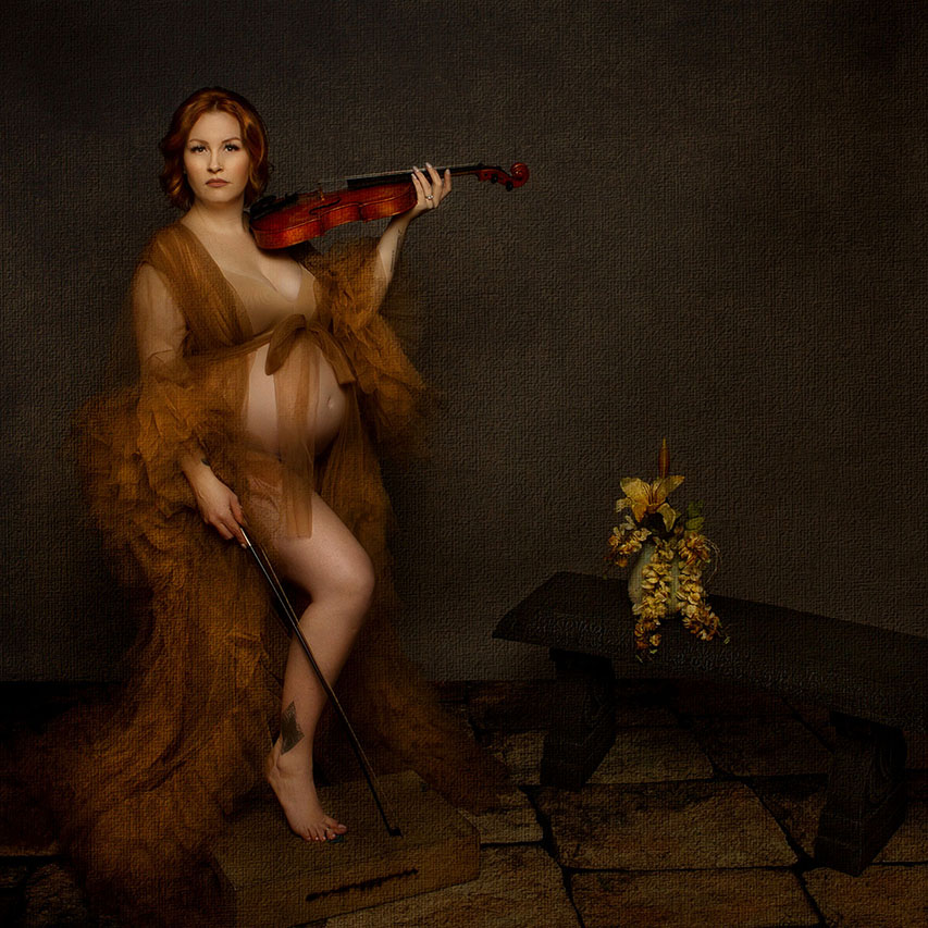 maternity-photography portrait of a women in a robe holding a violin by Birth and Beauty