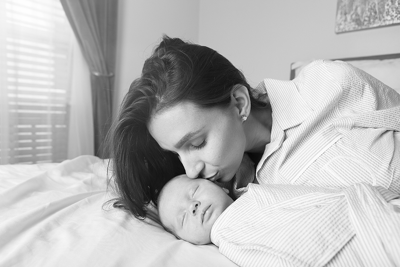 Orange county lifestle newborn photographer captures a mother looking at her newborn son.