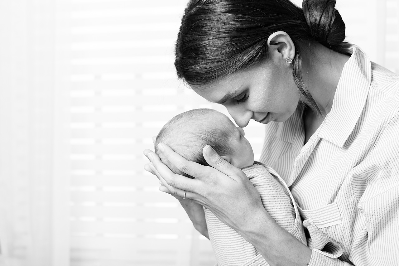 black and while newborn image of a mother holding her baby by Leona Darnell