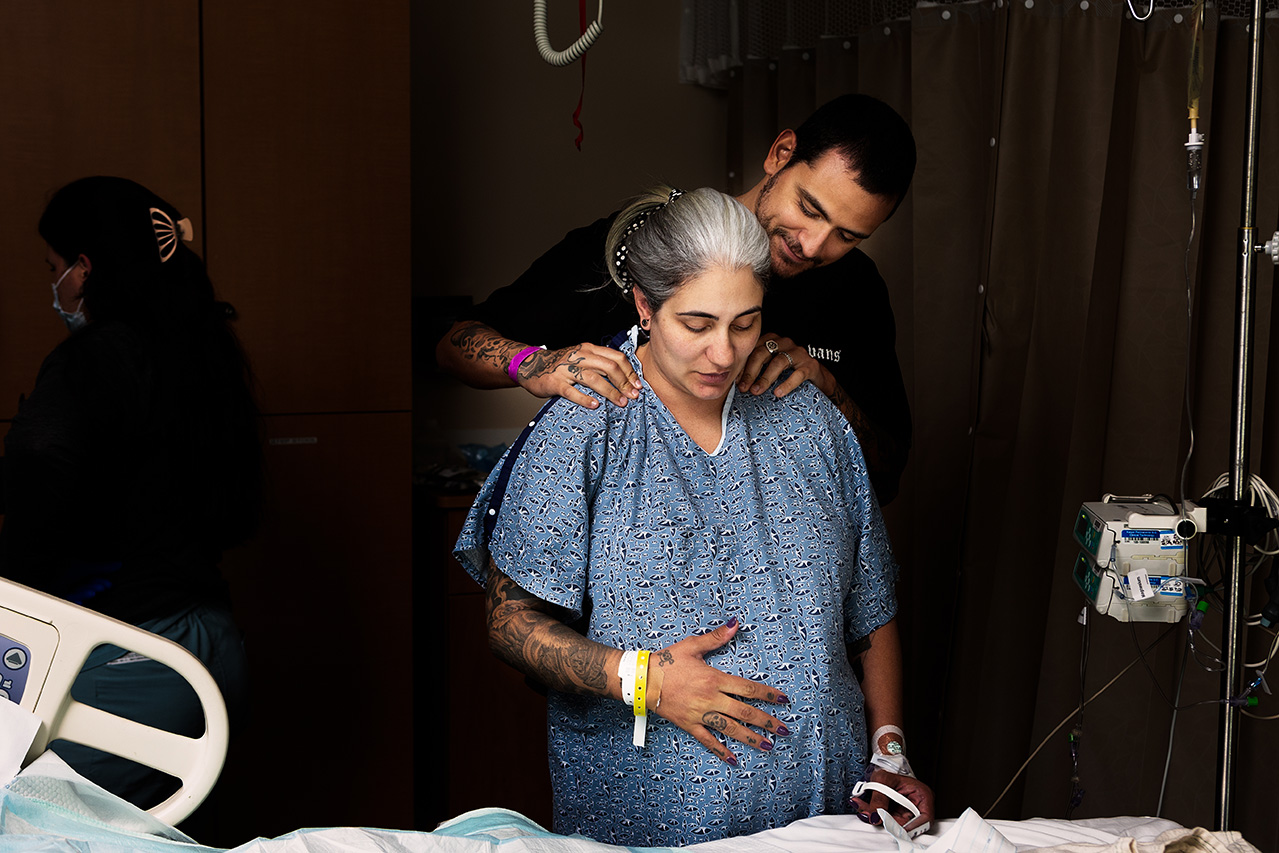 Birth photography photo of a woman during labor with her husband.