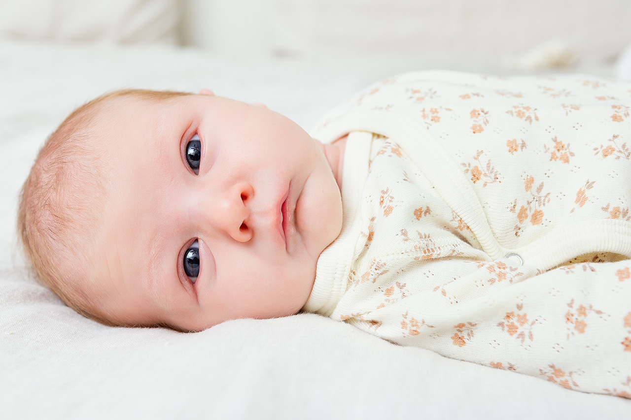 Lifestyle newborn photo of an alert baby