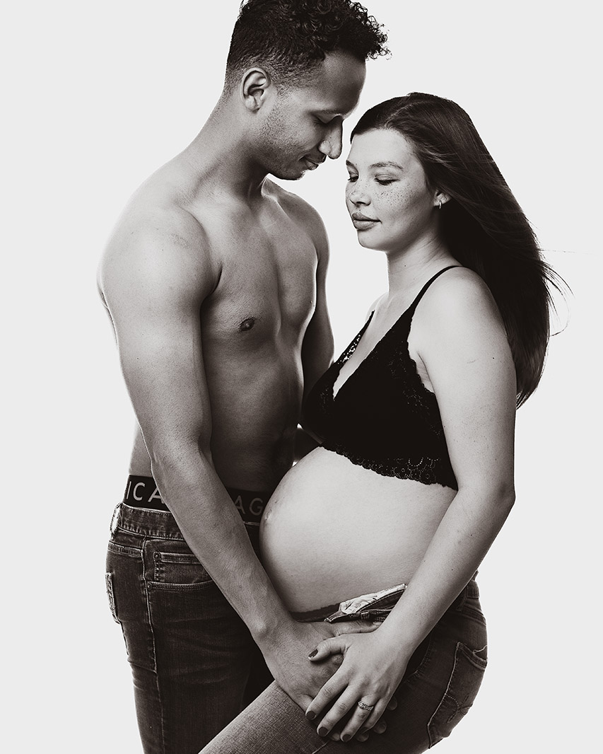 black and white image of a couple during a pregnancy photoshoot.