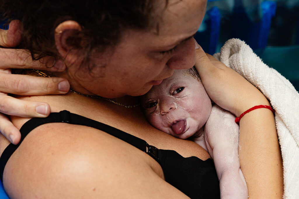 birth photography photo of a newborn with vernix by Leona Darnell