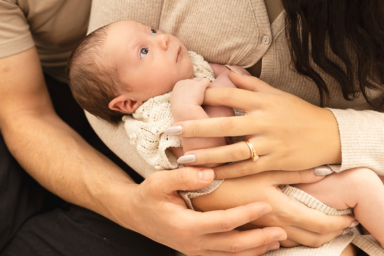 lifestyle newborn photo of a baby being held by Ls Angeles birth photographer, Leona Darnell