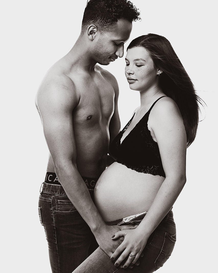 Classic black-and-white maternity portrait of an expectant couple with a refined, editorial style, photographed by Los Angeles birth and maternity photographer Leona Darnell.